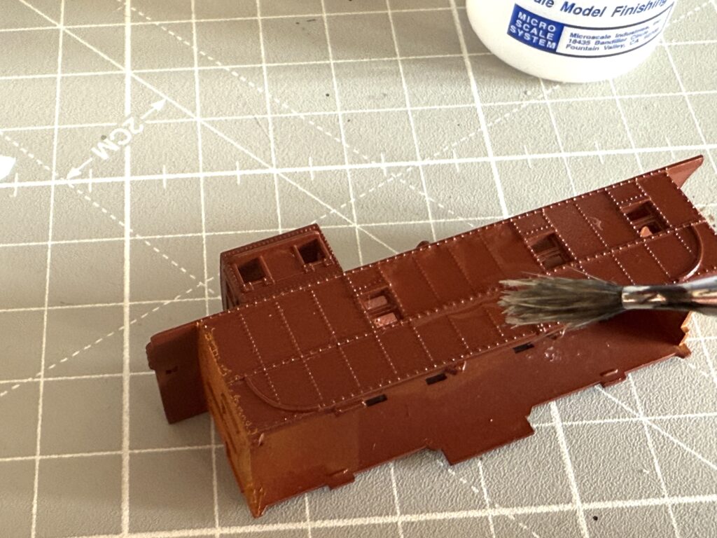 Painting an SP caboose: the surface where the decal will be applied is prepared with Microscale Micro Set solution